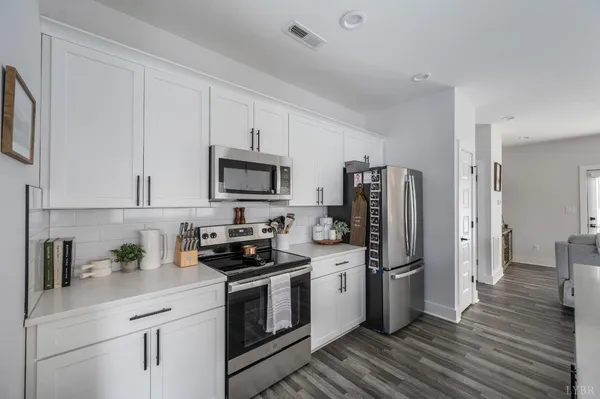 a kitchen with stainless steel appliances a refrigerator stove and sink