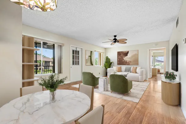 a living room with furniture potted plant and a window