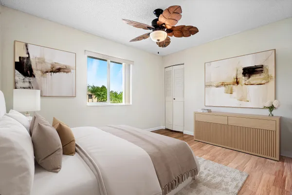 a bedroom with a bed and a chandelier
