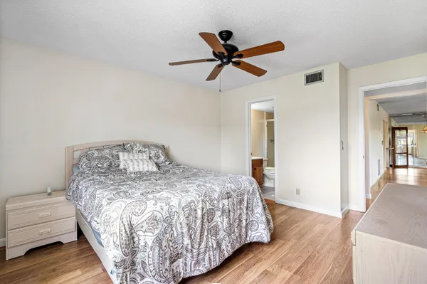 a bedroom with a bed and painting on the wall
