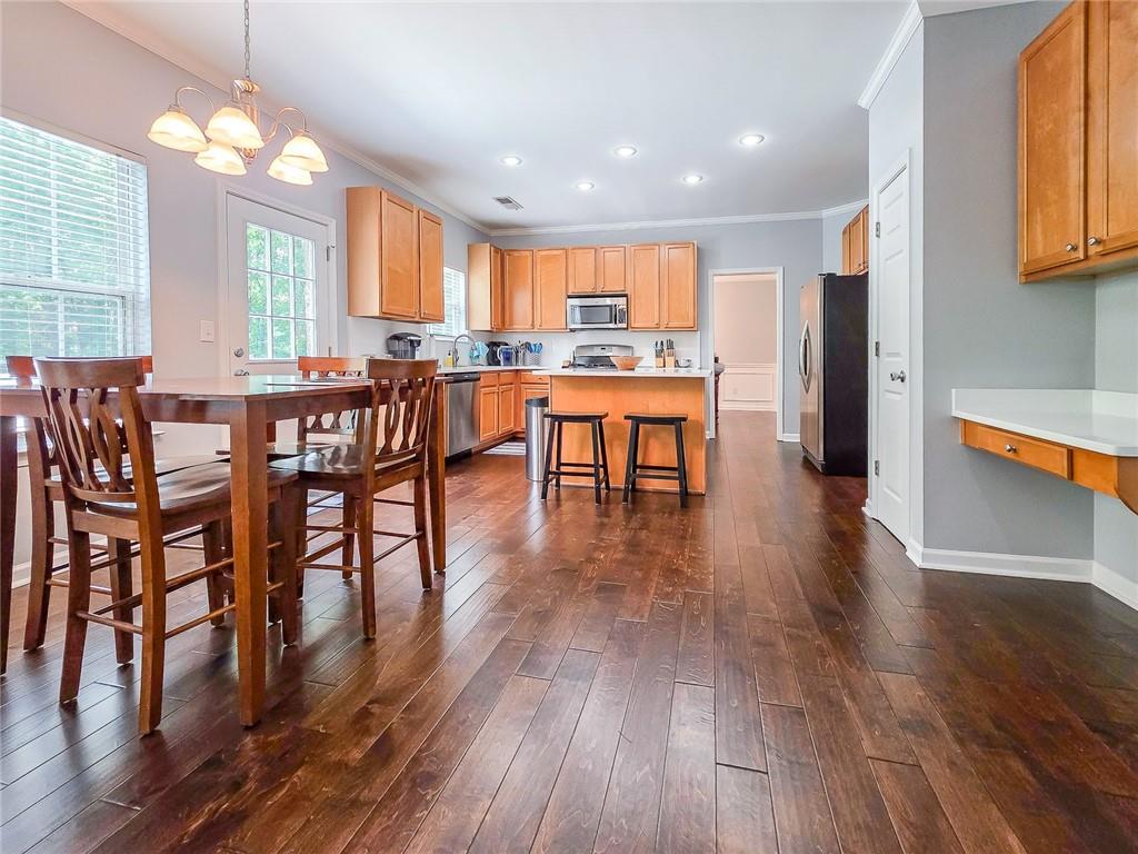 43 Ivy Mist Lane Acworth, GA 30101 - Photo 7 of 58 a view of a dining room with furniture and wooden floor