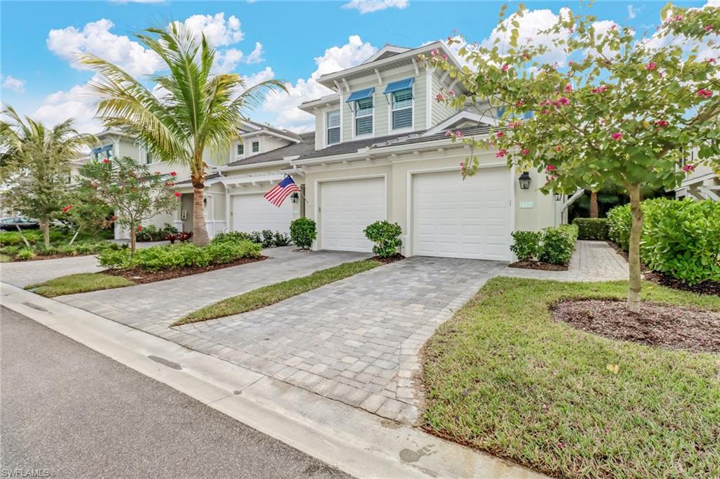 6959 Avalon Circle, Unit 1704 Naples, FL 34112 - Photo 1 of 25 a front view of a house with a yard and garage