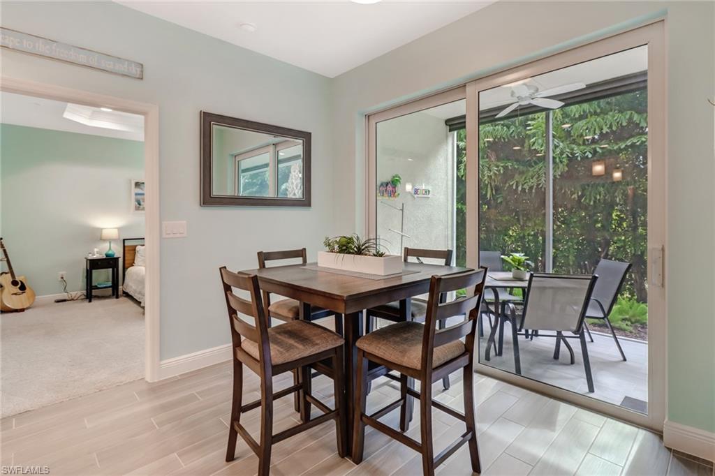 6959 Avalon Circle, Unit 1704 Naples, FL 34112 - Photo 11 of 25 a dining room with furniture and a floor to ceiling window