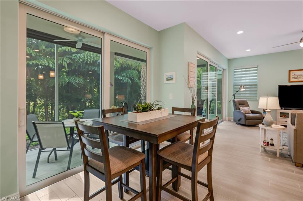 6959 Avalon Circle, Unit 1704 Naples, FL 34112 - Photo 12 of 25 a dining room with a table and chairs