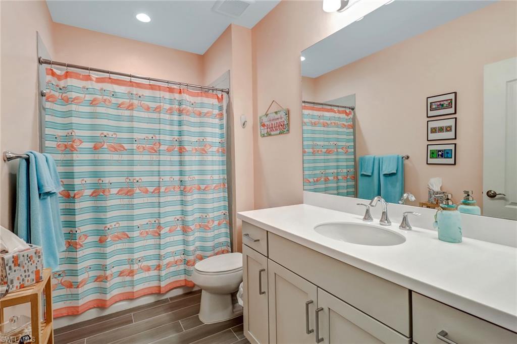 6959 Avalon Circle, Unit 1704 Naples, FL 34112 - Photo 15 of 25 a bathroom with a sink toilet and shower