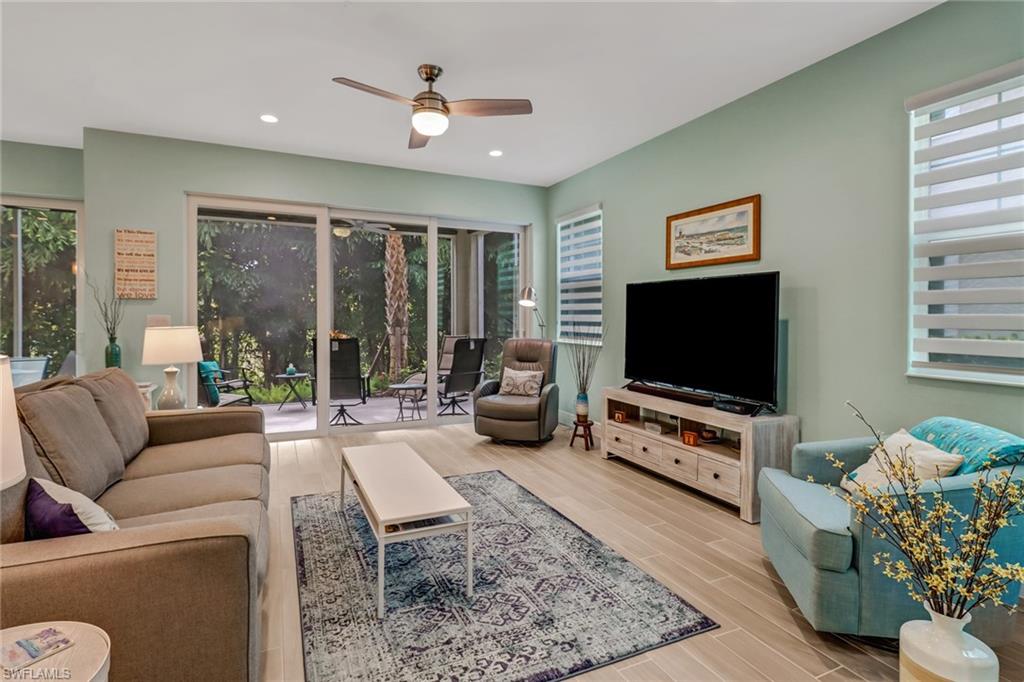 6959 Avalon Circle, Unit 1704 Naples, FL 34112 - Photo 7 of 25 a living room with furniture and a flat screen tv