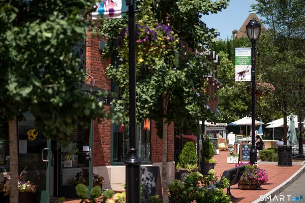 a living room with furniture a flat screen tv and a large window