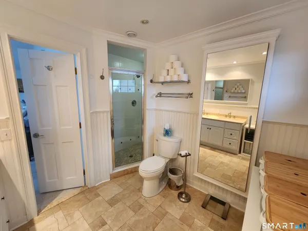 a spacious bedroom with a bed and a large window