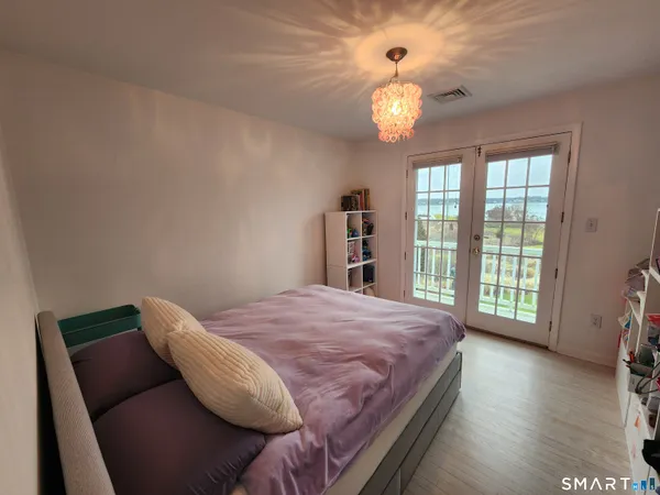 a spacious bedroom with a bed and a window