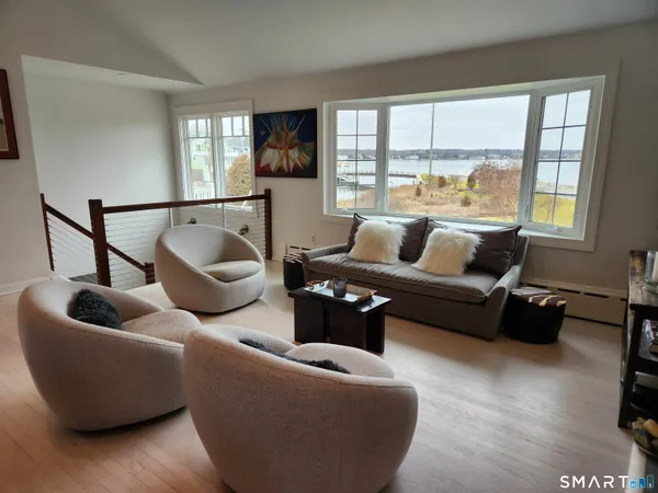 a dining room filled with furniture and wooden floor