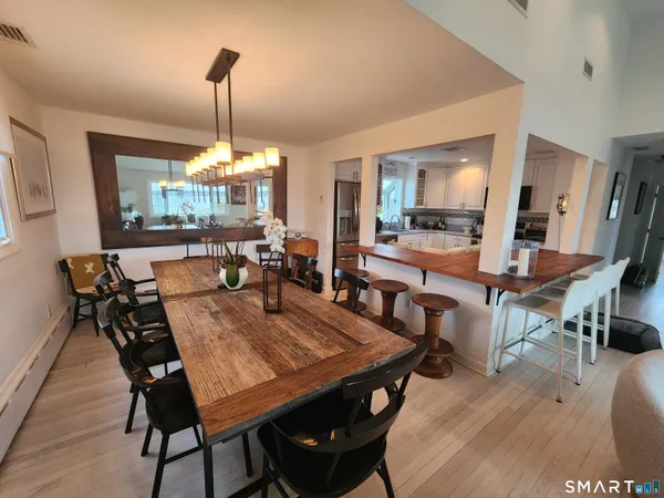 a dining room with furniture and wooden floor