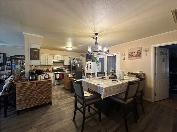 a view of a dining room with furniture and wooden floor