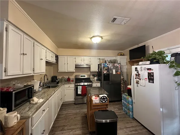 a kitchen with refrigerator and cabinets