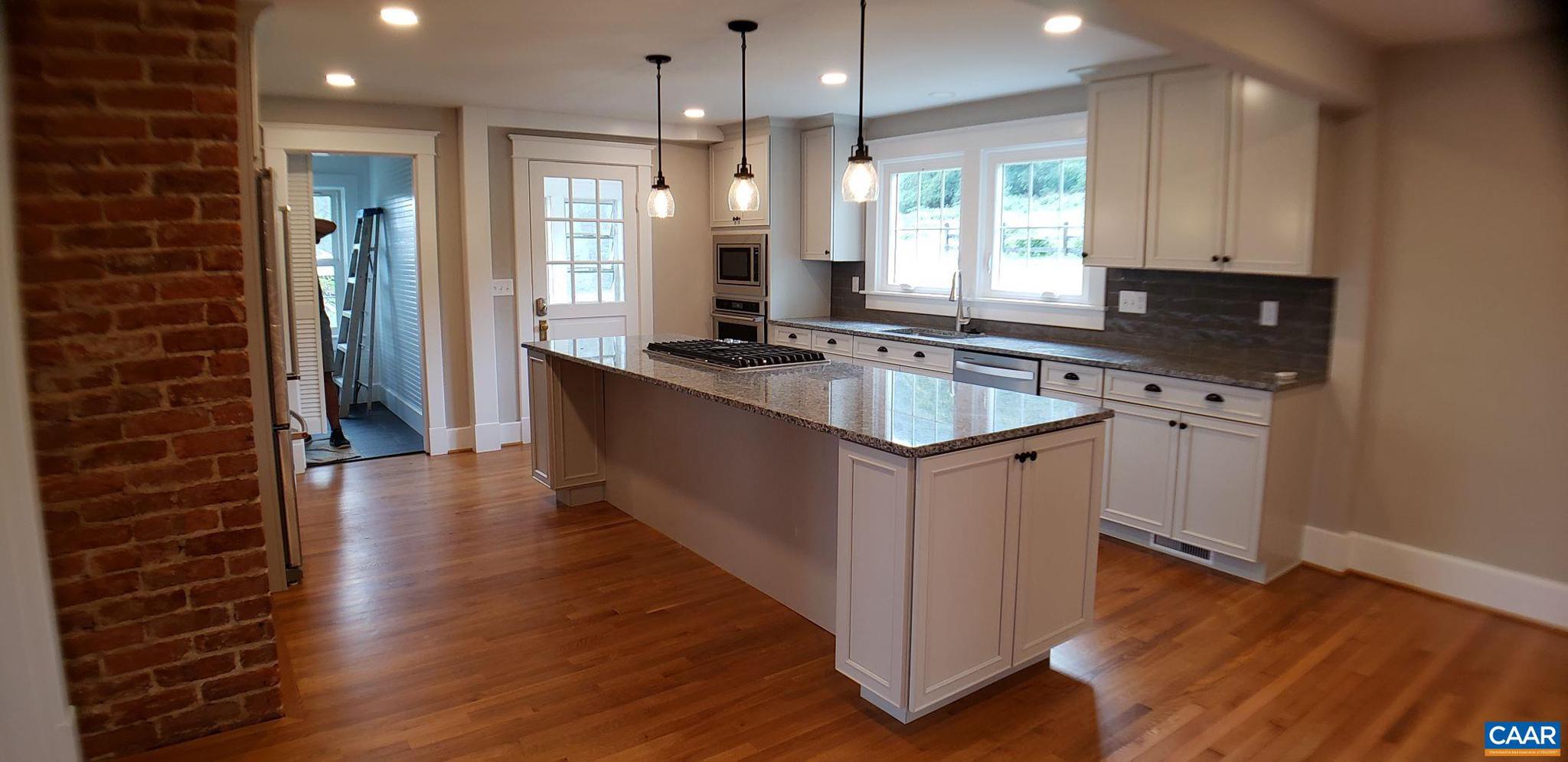 1874 White Hall Road Crozet, VA 22932 - Photo 13 of 39 a kitchen with stainless steel appliances granite countertop a sink stove and wooden floor