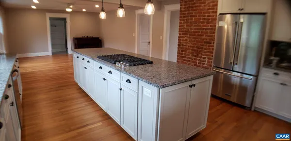 a kitchen with stainless steel appliances granite countertop a refrigerator and a stove