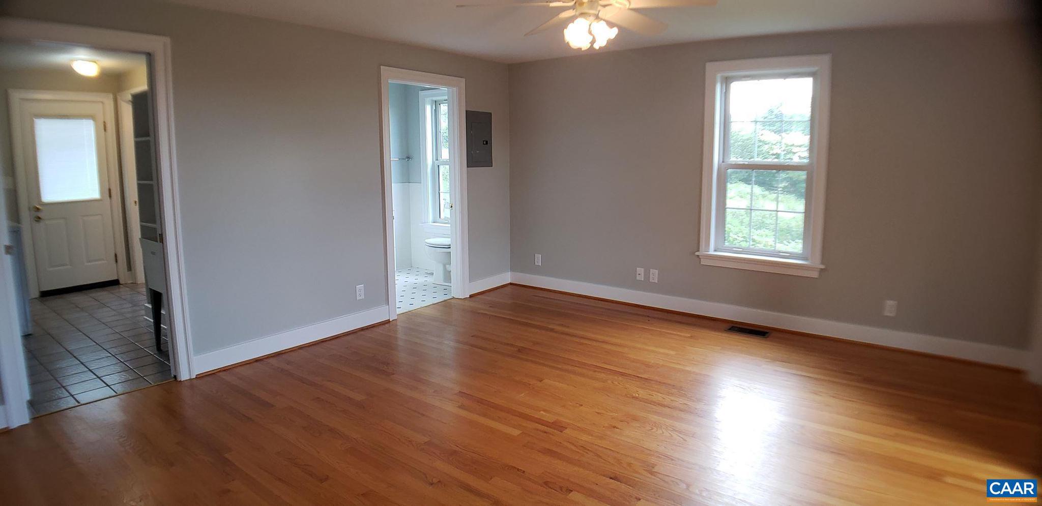 1874 White Hall Road Crozet, VA 22932 - Photo 19 of 39 an empty room with wooden floor and windows