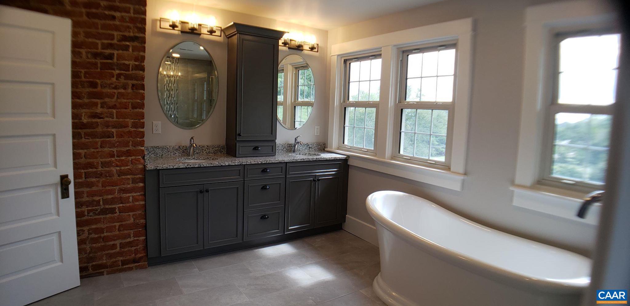 1874 White Hall Road Crozet, VA 22932 - Photo 34 of 39 a bathroom with a double vanity sink and a mirror