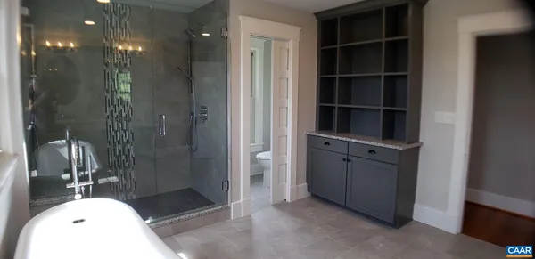 a bathroom with a granite countertop shower and a sink