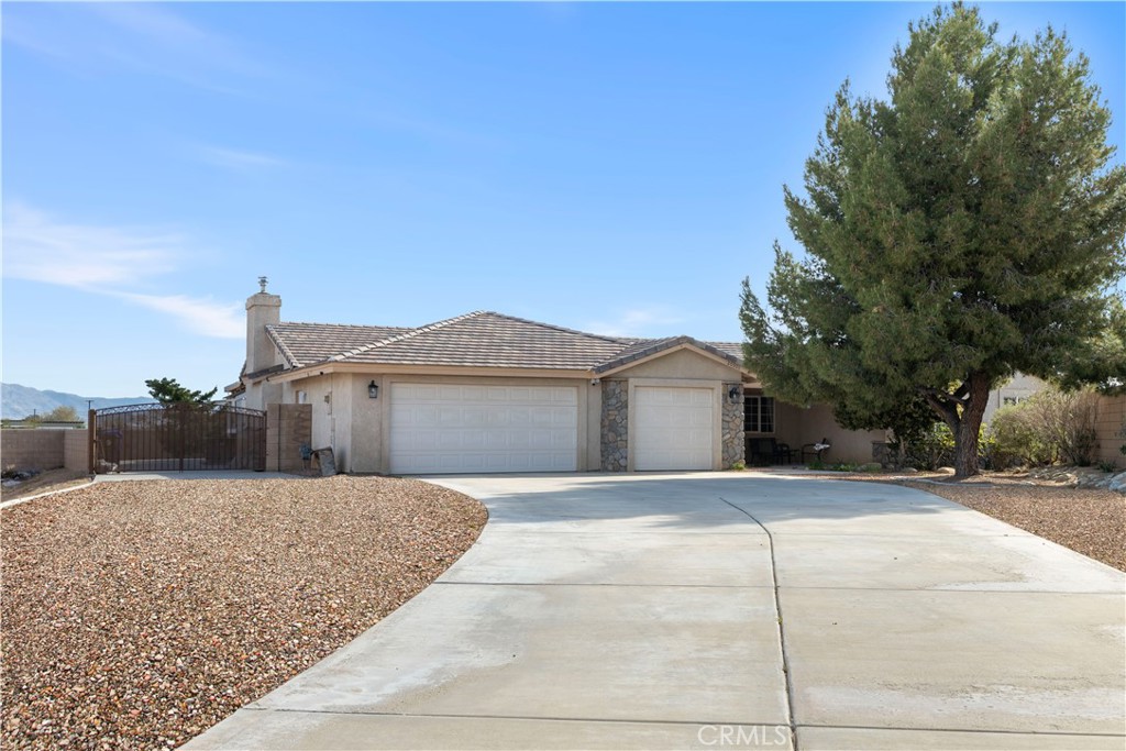 20301 Pima Road Apple Valley, CA 92308 - Photo 1 of 1 a front view of a house with a yard and garage