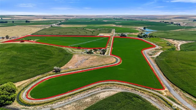 an aerial view of a golf course with a swimming pool