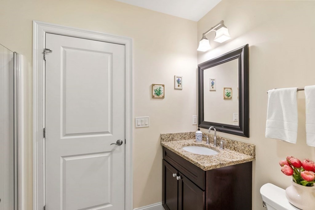 1 Hawes Road Sudbury, MA 01776 - Photo 17 of 38 a bathroom with a sink vanity and a mirror