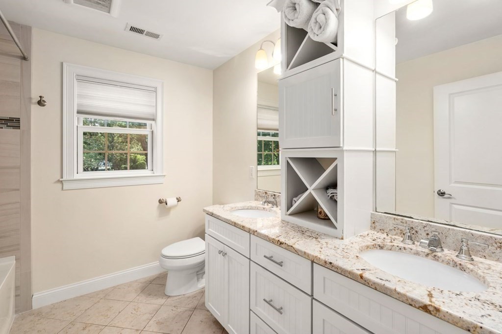 1 Hawes Road Sudbury, MA 01776 - Photo 23 of 38 a bathroom with a granite countertop sink a toilet and a mirror