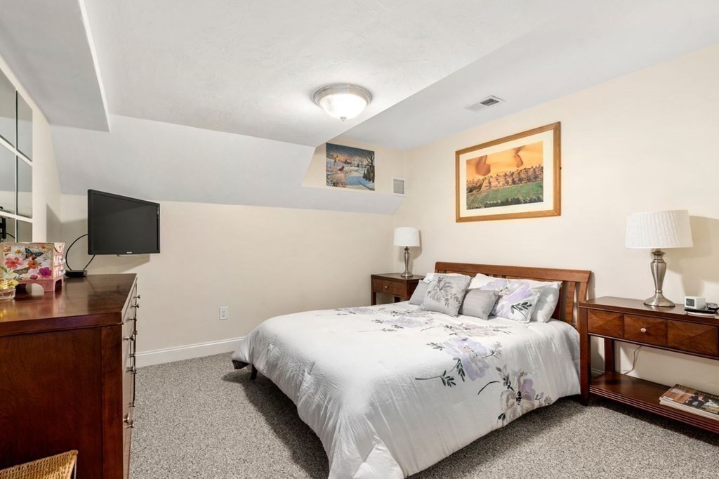 1 Hawes Road Sudbury, MA 01776 - Photo 27 of 38 a bedroom with a bed and a flat screen tv