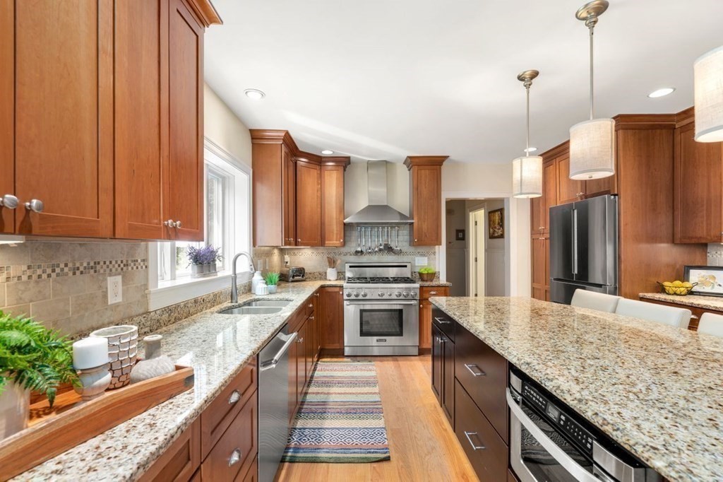 1 Hawes Road Sudbury, MA 01776 - Photo 10 of 38 a large kitchen with granite countertop a sink and a stove