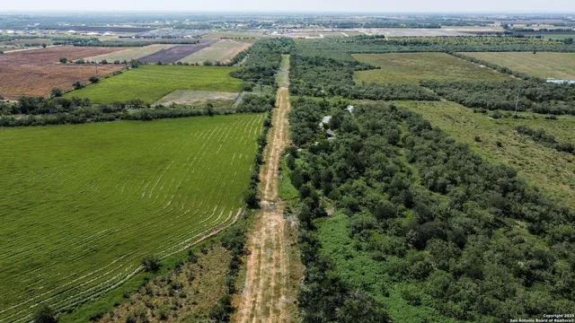 an aerial view of a houses with a yard