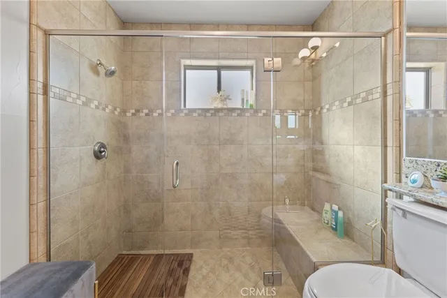 a bathroom with a shower and toilet