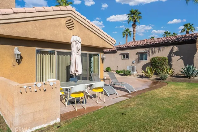 a view of an house with backyard space and sitting area