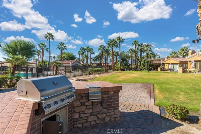 a view of a swimming pool with lawn chairs and a yard