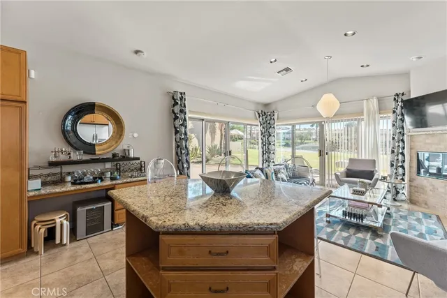 a kitchen with granite countertop a stove and a sink