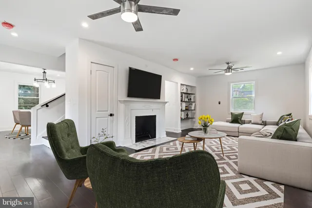 a living room with furniture a fireplace and a flat screen tv