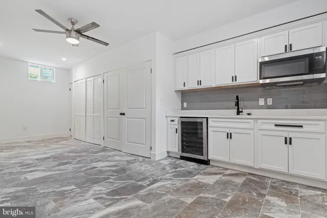 a kitchen with white cabinets and appliances