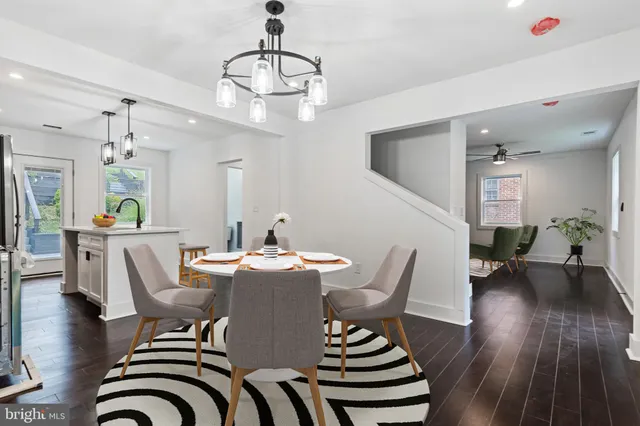 a view of a dining room with furniture wooden floor and chandelier