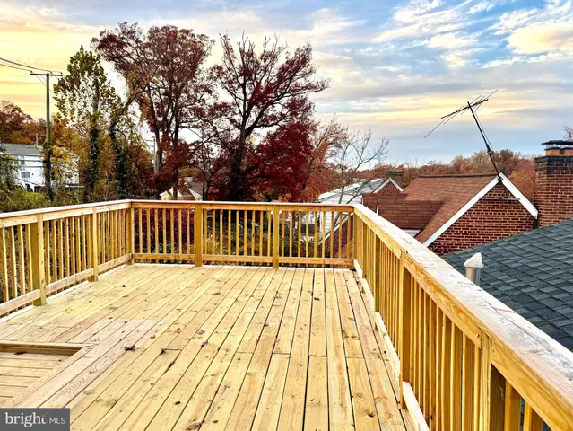 a view of balcony with wooden floor and fence