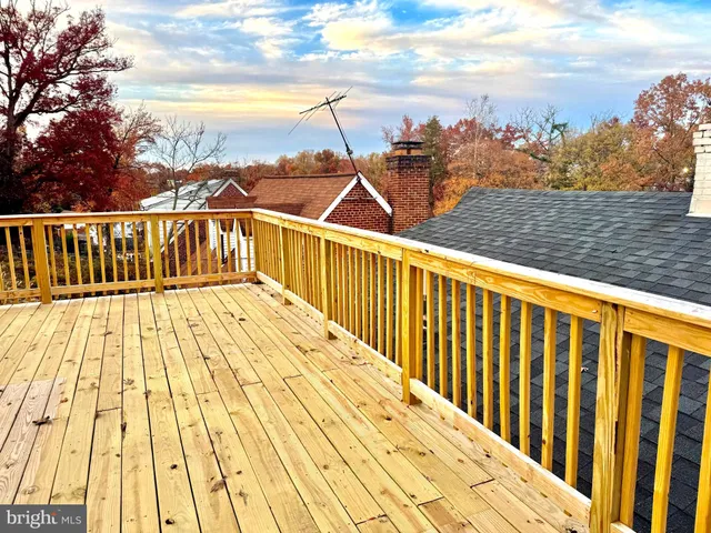a view of balcony with wooden floor and fence