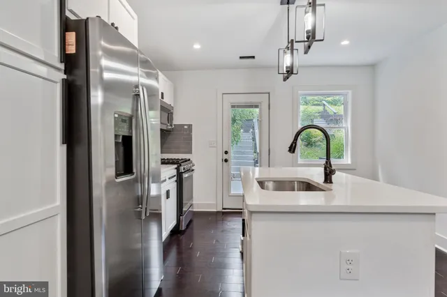 a kitchen with a refrigerator and a sink