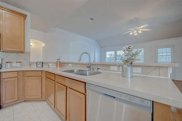 a kitchen with stainless steel appliances granite countertop a sink a stove and a refrigerator