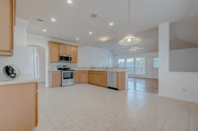 a kitchen with sink and white cabinets