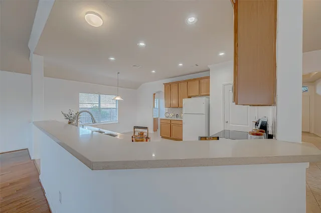 a large kitchen with stainless steel appliances a large counter top and a stove top oven