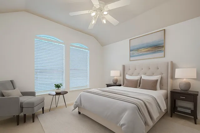 a bedroom with a bed and a potted plant