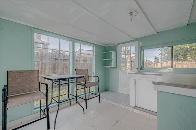 a view of an empty room with a chandelier fan