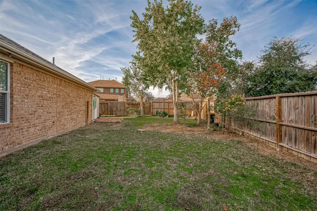 a backyard of a house with table and chairs