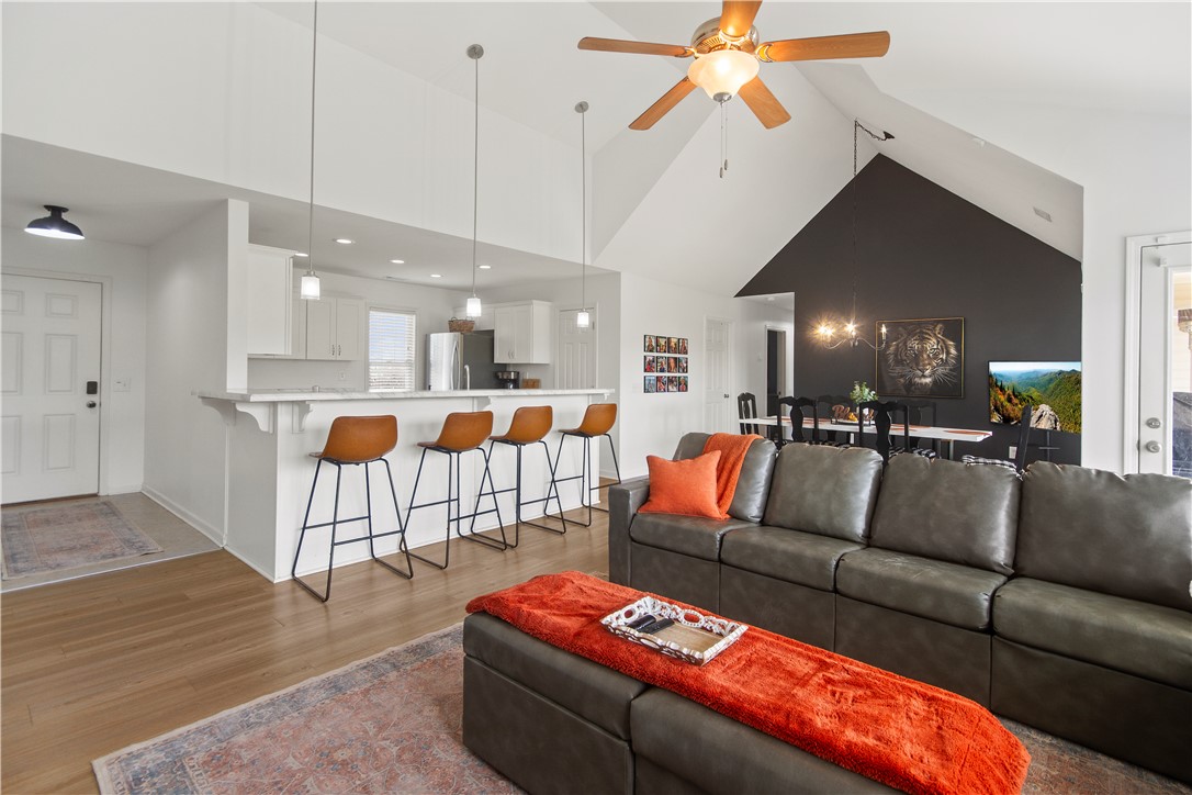 2900 Highway 187 Anderson, SC 29626 - Photo 8 of 41 An open concept living area showcases vaulted ceilings and wood flooring, perfect for gatherings.