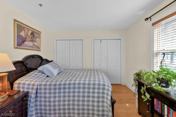 a bedroom with a bed and a bookshelf