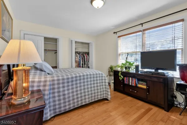 a bedroom with a bed and flat screen tv