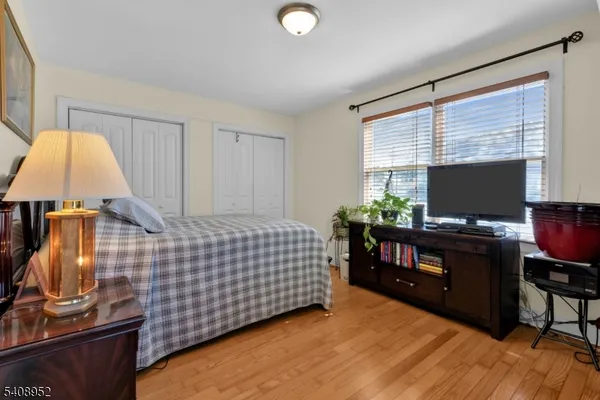 a bedroom with a bed and a flat tv screen