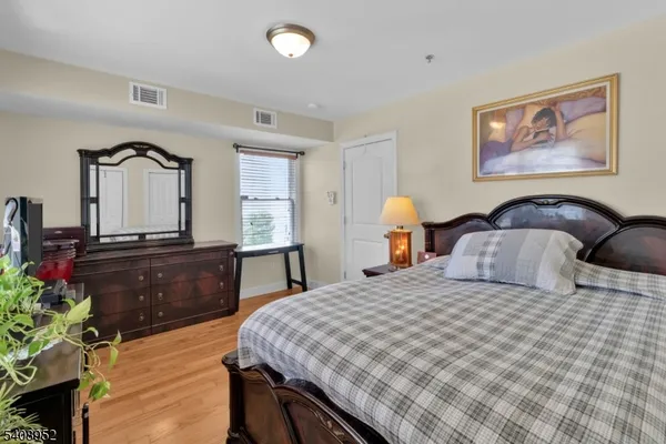 a bedroom with a large bed and a dresser
